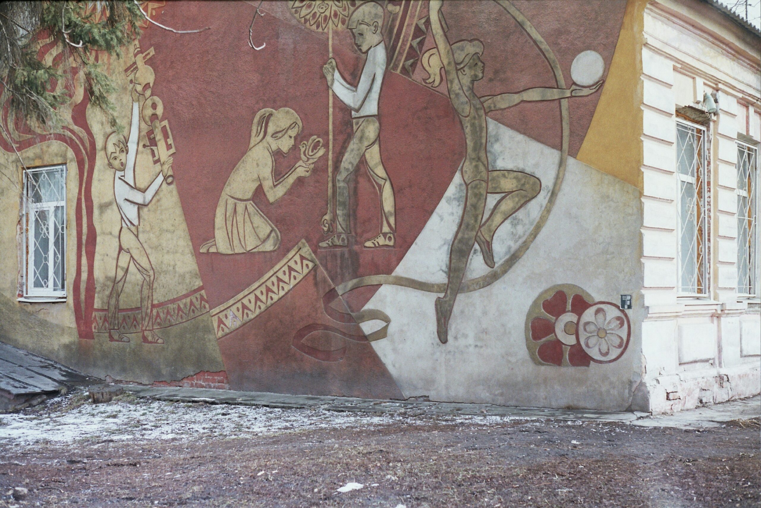 mural of a wall with a girl with flowers and a boy painting